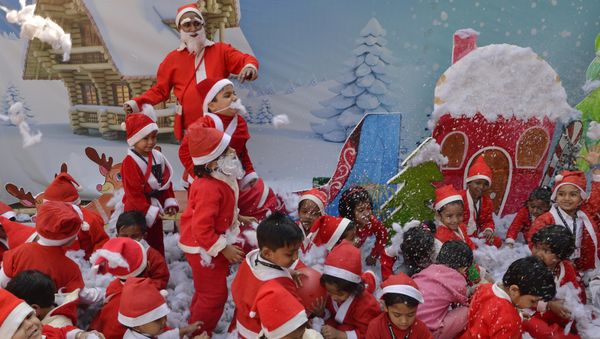 Indian school children dressed as Santa Claus take part in a Christmas event at a school in Siliguri Indian school children dressed as Santa Claus take part in a Christmas event at a school in Siliguri - Sputnik International