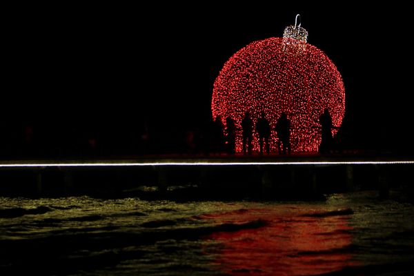 People are silhouetted on a pedestrian dock decorated with an illuminated Christmas ornament in the southern coastal city of Larnaca on the eastern Mediterranean island of Cyprus - Sputnik International