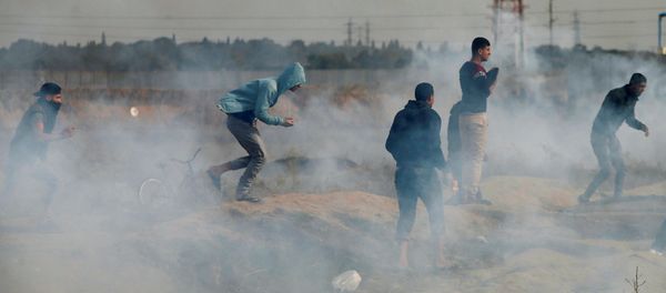 Palestinian demonstrators react to tear gas fired by Israeli troops during clashes at a protest as Palestinians call for a Day of Rage in response to U.S. President Donald Trump's recognition of Jerusalem as Israel's capital, near the border with Israel in the east of Gaza City, December 22, 2017 Palestinian demonstrators react to tear gas fired by Israeli troops during clashes at a protest as Palestinians call for a Day of Rage in response to U.S. President Donald Trump's recognition of Jerusalem as Israel's capital, near the border with Israel in the east of Gaza City, December 22, 2017 - Sputnik International