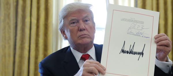U.S. President Donald Trump displays his signature after signing the $1.5 trillion tax overhaul plan along with a short-term government spending bill in the Oval Office of the White House in Washington, U.S U.S. President Donald Trump displays his signature after signing the $1.5 trillion tax overhaul plan along with a short-term government spending bill in the Oval Office of the White House in Washington, U.S - Sputnik International