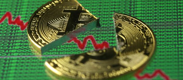 Broken representation of the Bitcoin virtual currency, placed on a monitor that displays stock graph and binary codes, are seen in this illustration picture, December 21, 2017 Broken representation of the Bitcoin virtual currency, placed on a monitor that displays stock graph and binary codes, are seen in this illustration picture, December 21, 2017 - Sputnik International