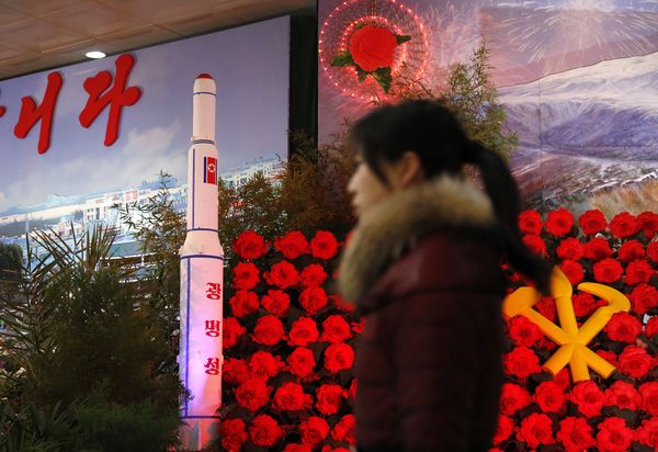 In this Feb. 15, 2016 file photo, a visitor at a flower festival walks past a model of North Korea's newest satellite Kwangmyongsong 4 on display In this Feb. 15, 2016 file photo, a visitor at a flower festival walks past a model of North Korea's newest satellite Kwangmyongsong 4 on display - Sputnik International