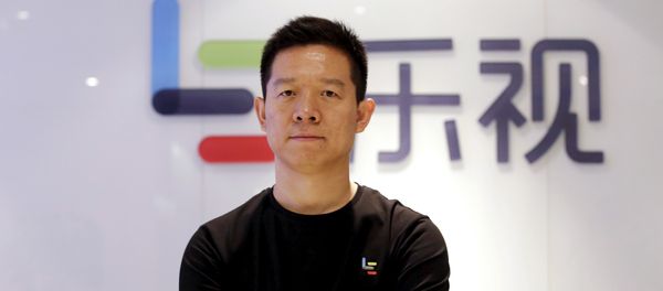 Jia Yueting, co-founder and head of Le Holdings Co Ltd, also known as LeEco and formerly as LeTV, poses for a photo in front of a logo of his company after a Reuters interview at LeEco headquarters in Beijing, China April 22, 2016 - Sputnik International