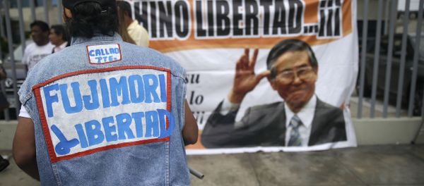 A supporter of former President Alberto Fujimori wears a jacket that says in Spanish Free Fujimori outside the clinic where the jailed leader was admitted the previous day after suffering a drop in blood pressure in Lima, Peru, Sunday, Dec. 24, 2017. The former strongman, who governed from 1990 to 2000, is a polarizing figure in Peru. Some Peruvians laud him for defeating the Maoist Shining Path guerrillas, while others loathe him for human rights violations carried out under his government. (AP Photo/Martin Mejia) A supporter of former President Alberto Fujimori wears a jacket that says in Spanish Free Fujimori outside the clinic where the jailed leader was admitted the previous day after suffering a drop in blood pressure in Lima, Peru, Sunday, Dec. 24, 2017. The former strongman, who governed from 1990 to 2000, is a polarizing figure in Peru. Some Peruvians laud him for defeating the Maoist Shining Path guerrillas, while others loathe him for human rights violations carried out under his government. (AP Photo/Martin Mejia) - Sputnik International
