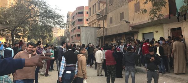 People are seen outside the Mar Mina Church after a blast, in Helwan district on the outskirts of Cairo, Egypt after a blast December 29, 2017 - Sputnik International