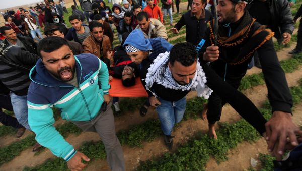 A wounded Palestinian demonstrator is evacuated during clashes with Israeli troops at a protest against U.S. President Donald Trump's decision to recognize Jerusalem as the capital of Israel, near the border with Israel in the southern Gaza Strip December 29, 2017 A wounded Palestinian demonstrator is evacuated during clashes with Israeli troops at a protest against U.S. President Donald Trump's decision to recognize Jerusalem as the capital of Israel, near the border with Israel in the southern Gaza Strip December 29, 2017 - Sputnik International