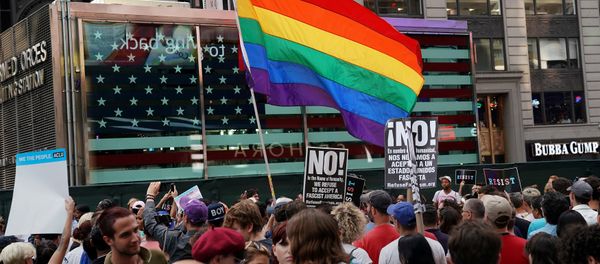 A rainbow flag flies as people protest U.S. President Donald Trump's announcement that he plans to reinstate a ban on transgender individuals from serving in any capacity in the U.S. military, in Times Square, in New York City, New York, U.S., July 26, 2017. A rainbow flag flies as people protest U.S. President Donald Trump's announcement that he plans to reinstate a ban on transgender individuals from serving in any capacity in the U.S. military, in Times Square, in New York City, New York, U.S., July 26, 2017. - Sputnik International