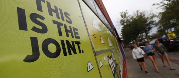 In this Sunday, Aug. 20, 2017, photo, a sign is affixed to the window of an information cafe named Mutiny as pedestrians pass by in south Denver. Shop owner Jim Norris is hoping to license his storefront as one of the nation's first legal marijuana clubs. In this Sunday, Aug. 20, 2017, photo, a sign is affixed to the window of an information cafe named Mutiny as pedestrians pass by in south Denver. Shop owner Jim Norris is hoping to license his storefront as one of the nation's first legal marijuana clubs. - Sputnik International