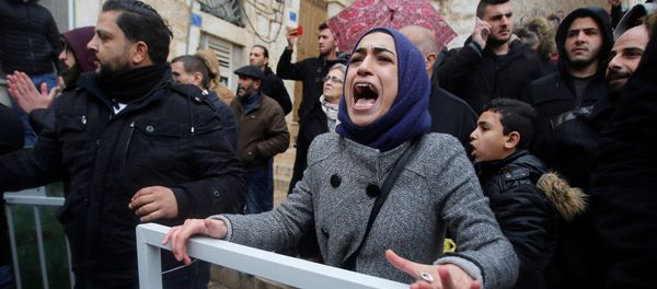 A demonstrator reacts during a protest against the visit of Greek Orthodox Patriarch of Jerusalem Theophilos III, in the West Bank city of Bethlehem January 6, 2018 - Sputnik International