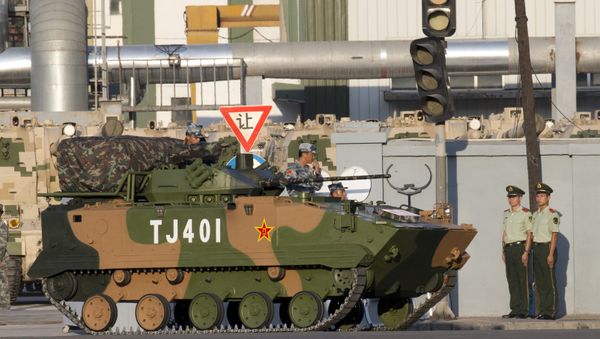 In this Aug. 22, 2015 file photo, a Chinese ZBD-03 airborne armored infantry fighting vehicle waits to take part in a rehearsal for a large military parade in Beijing. When China rolls out its latest armaments Thursday, Sept. 3 - Sputnik International