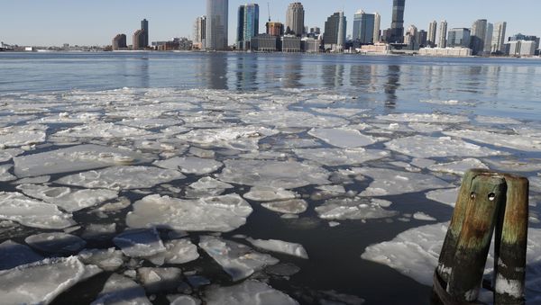 Ice floats in the Hudson River in Lower Manhattan with Jersery City, N.J., visible across the river, Sunday, Jan. 7, 2018, as bitterly cold temperatures continued through the weekend in New York Ice floats in the Hudson River in Lower Manhattan with Jersery City, N.J., visible across the river, Sunday, Jan. 7, 2018, as bitterly cold temperatures continued through the weekend in New York - Sputnik International