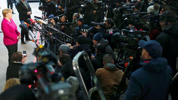 Leader of the Christian Democratic Union (CDU) and the acting German Chancellor Angela Merkel delivers a statement before exploratory talks about forming a new coalition government at the SPD headquarters in Berlin, Germany, January 7, 2018 - Sputnik International