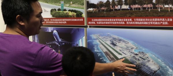 In this Thursday, July 27, 2017, file photo, a man and a child look at a picture showing the Fiery Cross Reef in the Spratly islands, in the disputed South China Sea, on display at the military museum in Beijing - Sputnik International