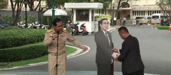 In this image from video, Thailand's Prime Minister Prayuth Chan-ocha, left, directs the scene as a life-sized cardboard cut-out figure of himself is carried into view by an aid, in Bangkok, Thailand, Monday Jan. 8, 2018. - Sputnik International