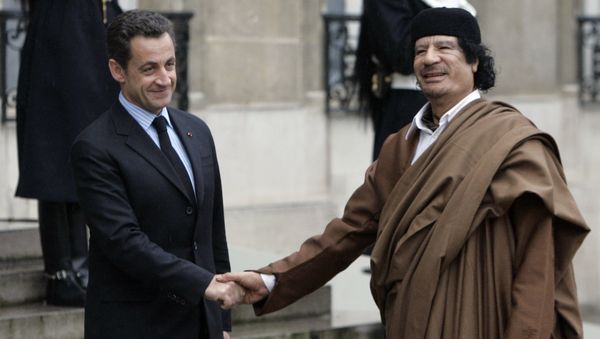 French President Nicolas Sarkozy, left, greets Libyan leader Col. Moammar Gadhafi upon his arrival at the Elysee Palace, in Paris. (File) - Sputnik International