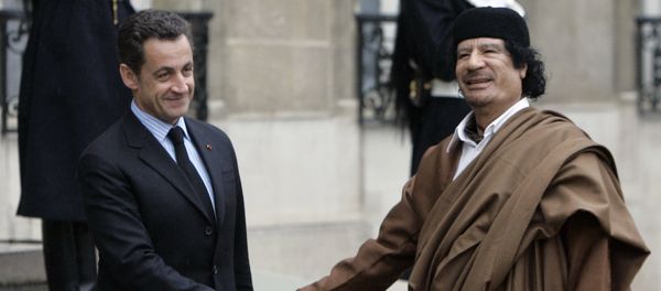 French President Nicolas Sarkozy, left, greets Libyan leader Col. Moammar Gadhafi upon his arrival at the Elysee Palace, in Paris. (File) - Sputnik International