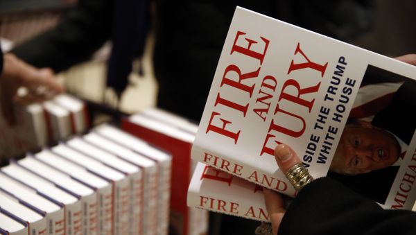 A customer looks at a copy of Michael Wolff's Fire and Fury: Inside the Trump White House as they go on sale at a bookshop, in London, Tuesday, Jan. 9, 2018. - Sputnik International