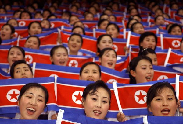 North Korean cheer team members wave their national flags during the World Students Games opening ceremony in Daegu on 21 August 2003 - Sputnik International