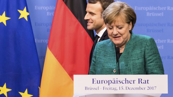 French President Emmanuel Macron, left, passes by German Chancellor Angela Merkel prior to addressing a media conference at an EU summit in Brussels on Friday, Dec. 15, 2017. French President Emmanuel Macron, left, passes by German Chancellor Angela Merkel prior to addressing a media conference at an EU summit in Brussels on Friday, Dec. 15, 2017. - Sputnik International