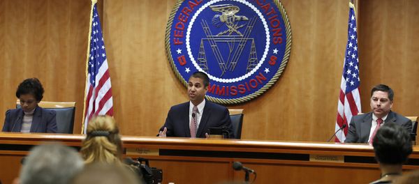 Federal Communications Commission (FCC) Chairman Ajit Pai, center, announces the vote was approved to repeal net neutrality, next to Commissioner Mignon Clyburn, left, who voted no, and Commissioner Michael O'Rielly, who voted yes, at the FCC, Thursday, Dec. 14, 2017, in Washington. (File) Federal Communications Commission (FCC) Chairman Ajit Pai, center, announces the vote was approved to repeal net neutrality, next to Commissioner Mignon Clyburn, left, who voted no, and Commissioner Michael O'Rielly, who voted yes, at the FCC, Thursday, Dec. 14, 2017, in Washington. (File) - Sputnik International