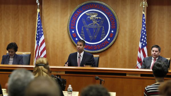 Federal Communications Commission (FCC) Chairman Ajit Pai, center, announces the vote was approved to repeal net neutrality, next to Commissioner Mignon Clyburn, left, who voted no, and Commissioner Michael O'Rielly, who voted yes, at the FCC, Thursday, Dec. 14, 2017, in Washington. (File) - Sputnik International