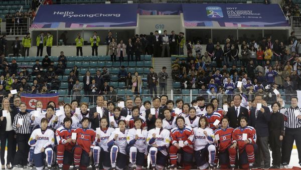 FILE - In this April 6, 2017, file photo, women's ice hockey players of South Korea, in white, and North Korea, in red, pose for a photo with International Ice Hockey Federation officials after their Ice Hockey Women's World Championship Division II Group A game in Gangneung, South Korea. North and South Korea agreed on Monday, Jan. 15, 2018, in principle to field a joint women's ice hockey team during next month's Olympics in South Korea, and relayed their position to the International Olympic Committee FILE - In this April 6, 2017, file photo, women's ice hockey players of South Korea, in white, and North Korea, in red, pose for a photo with International Ice Hockey Federation officials after their Ice Hockey Women's World Championship Division II Group A game in Gangneung, South Korea. North and South Korea agreed on Monday, Jan. 15, 2018, in principle to field a joint women's ice hockey team during next month's Olympics in South Korea, and relayed their position to the International Olympic Committee - Sputnik International
