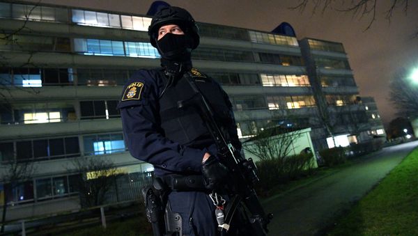 A policeman looks on after an object exploded next to a police station in Rosengard, Malmo (photo used for illustration only) A policeman looks on after an object exploded next to a police station in Rosengard, Malmo (photo used for illustration only) - Sputnik International