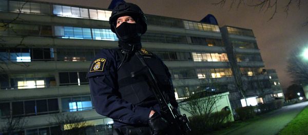 A policeman looks on after an object exploded next to a police station in Rosengard, Malmo (photo used for illustration only) A policeman looks on after an object exploded next to a police station in Rosengard, Malmo (photo used for illustration only) - Sputnik International