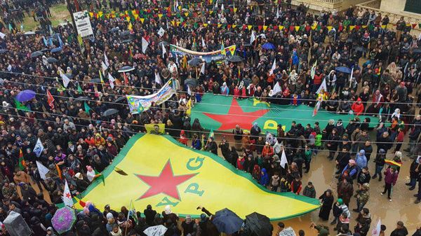 Protesters waving giant flags of the YPG and other parties and militias, during a demonstration against Turkish threats, in Afrin, Aleppo province, north Syria Protesters waving giant flags of the YPG and other parties and militias, during a demonstration against Turkish threats, in Afrin, Aleppo province, north Syria - Sputnik International