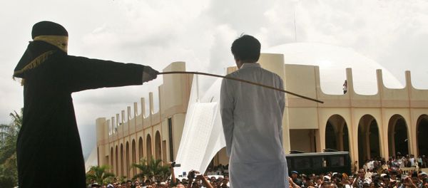 A Sharia law official whips a man , Aceh province, Indonesia (File) - Sputnik International