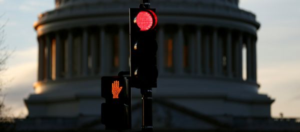 A traffic light shines red after President Donald Trump and the U.S. Congress failed to reach a deal on funding for federal agencies in Washington, U.S., January 20, 2018 A traffic light shines red after President Donald Trump and the U.S. Congress failed to reach a deal on funding for federal agencies in Washington, U.S., January 20, 2018 - Sputnik International