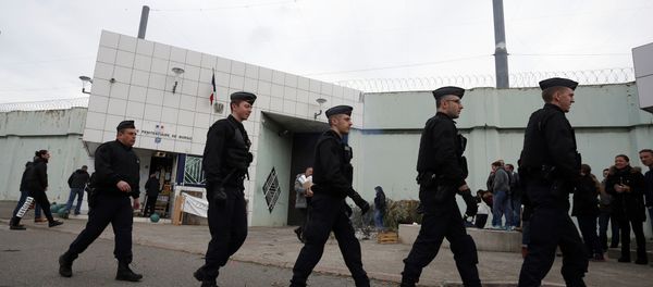 Riot police officers walk by Borgo prison on January 22, 2018 on the French Mediterranean Island of Corsica, as striking prison guards block its access as part of a nationwide movement to call for better safety and wages Riot police officers walk by Borgo prison on January 22, 2018 on the French Mediterranean Island of Corsica, as striking prison guards block its access as part of a nationwide movement to call for better safety and wages - Sputnik International