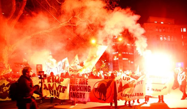 Protesters with banners light flares during a demonstration against U.S. President Trump in Zurich Protesters with banners light flares during a demonstration against U.S. President Trump in Zurich - Sputnik International
