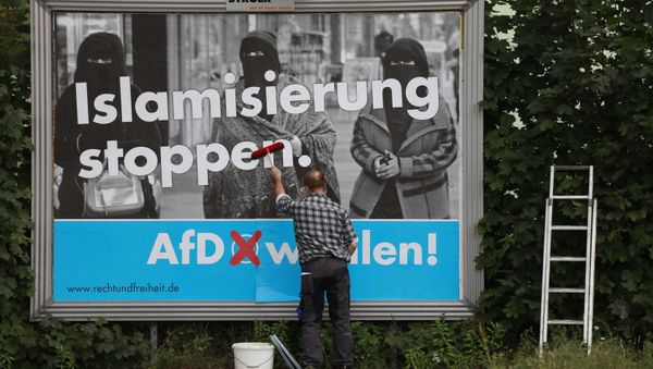 A man sticks an Alternative for Germany (AfD)'s electoral poster reading stop islamization in Berlin on September 7, 2017 A man sticks an Alternative for Germany (AfD)'s electoral poster reading stop islamization in Berlin on September 7, 2017 - Sputnik International