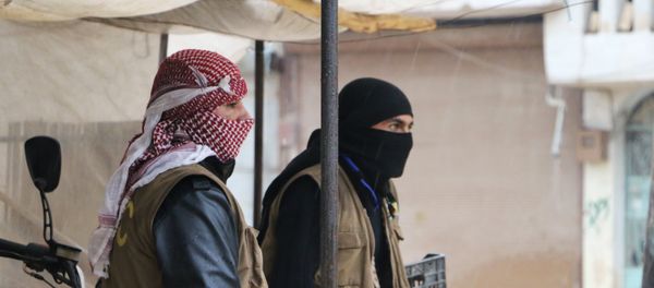 Syrian fighters from the Kurdish People's Protection Units (YPG) look on during the funeral of a comrade in the Kurdish-majority town of Afrin in northern Syria, on January 23, 2018, as Turkish troops and their Syrian rebel allies pressed an assault on the border enclave Syrian fighters from the Kurdish People's Protection Units (YPG) look on during the funeral of a comrade in the Kurdish-majority town of Afrin in northern Syria, on January 23, 2018, as Turkish troops and their Syrian rebel allies pressed an assault on the border enclave - Sputnik International