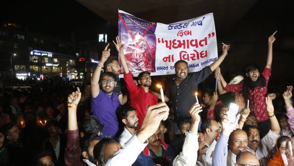 Members of India's Rajput community holds a banner and candles and shouts slogans during a protest against the release of Bollywood film Padmaavat in Ahmadabad, India - Sputnik International