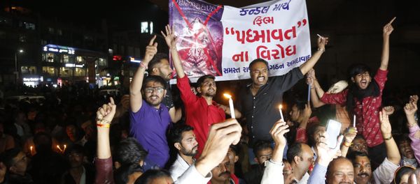Members of India's Rajput community holds a banner and candles and shouts slogans during a protest against the release of Bollywood film Padmaavat in Ahmadabad, India Members of India's Rajput community holds a banner and candles and shouts slogans during a protest against the release of Bollywood film Padmaavat in Ahmadabad, India - Sputnik International