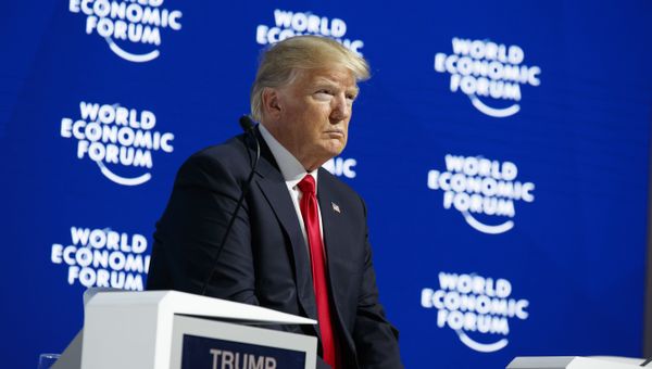 President Donald Trump listens as he is introduced to deliver a speech to the World Economic Forum, Friday, Jan. 26, 2018, in Davos - Sputnik International