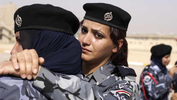 A newly graduated Iraqi police women sheds tears during a graduation ceremony, at the Police College, Ministry of Interior Complex, in Baghdad A newly graduated Iraqi police women sheds tears during a graduation ceremony, at the Police College, Ministry of Interior Complex, in Baghdad - Sputnik International