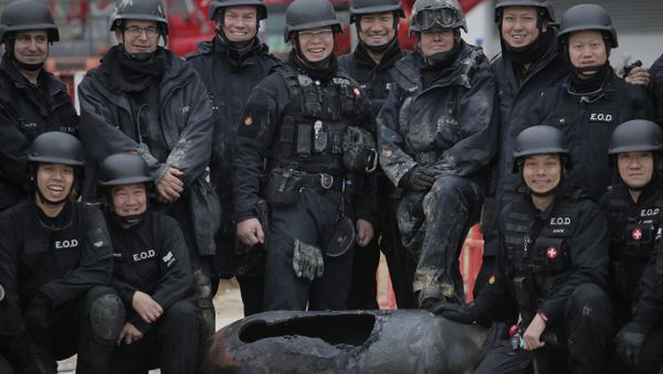 Police officers from explosive ordinance disposal pose with a deactivated bomb for a photo at the scene in the Wan Chai district of Hong Kong, Thursday, Feb.1, 2018. Hong Kong police worked overnight to neutralize the large unexploded wartime bomb after it was unearthed on Wednesday during construction work in the Asian financial center. - Sputnik International