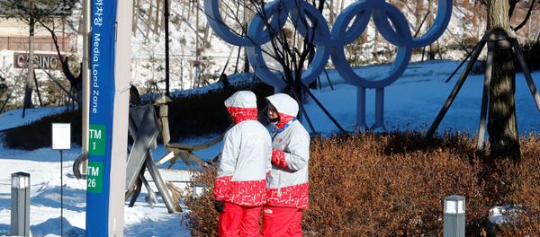 Volunteers walk beside the Olympic rings at the Alpensia resort for the upcoming 2018 Pyeongchang Winter Olympic Games in Pyeongchang, South Korea, January 23, 2018 Volunteers walk beside the Olympic rings at the Alpensia resort for the upcoming 2018 Pyeongchang Winter Olympic Games in Pyeongchang, South Korea, January 23, 2018 - Sputnik International