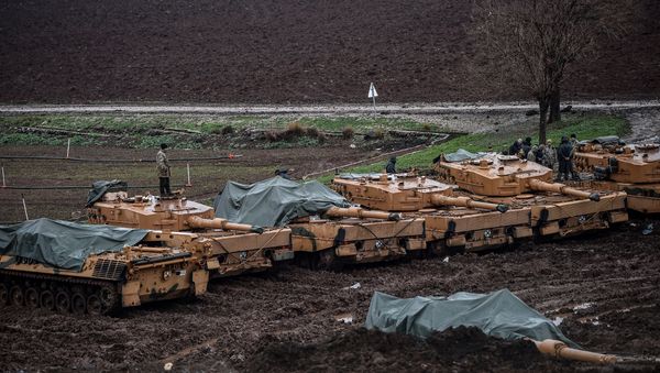 Turkish soldiers stand on their German-made Leopard 2A4 battle tanks stationed in a field near the Syrian border at Hassa, in Hatay province - Sputnik International