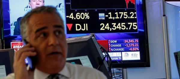 A trader works on the floor following the closing bell as a screen shows the Dow Jones Industrial Average on the New York Stock Exchange, (NYSE) in New York, U.S., February 5, 2018 A trader works on the floor following the closing bell as a screen shows the Dow Jones Industrial Average on the New York Stock Exchange, (NYSE) in New York, U.S., February 5, 2018 - Sputnik International