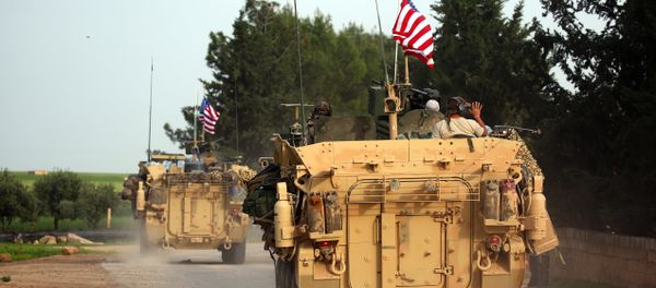 US forces, accompanied by Kurdish People's Protection Units (YPG) fighters, drive their armoured vehicles near the northern Syrian village of Darbasiyah, on the border with Turkey on April 28, 2017. (File) - Sputnik International