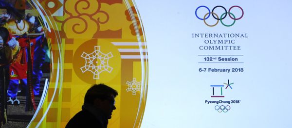 A member of the International Olympic Committee walks past a display during the 132nd IOC Session prior to the 2018 Winter Olympics in Pyeongchang, South Korea, Wednesday, Feb. 7, 2018 A member of the International Olympic Committee walks past a display during the 132nd IOC Session prior to the 2018 Winter Olympics in Pyeongchang, South Korea, Wednesday, Feb. 7, 2018 - Sputnik International