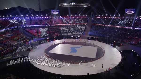 Athletes from North and South Korea wave Korean unification flags as they walk on stage during the opening ceremony of the 2018 Winter Olympics in Pyeongchang, South Korea, Friday, Feb. 9, 2018 - Sputnik International