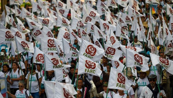 FARC members and supporters wave flags with the new logo of the rebaptized FARC (Common Alternative Revolutionary Force), transformed into a political party following its disarmament, during the closing of their National Congress in Bogota. (File) FARC members and supporters wave flags with the new logo of the rebaptized FARC (Common Alternative Revolutionary Force), transformed into a political party following its disarmament, during the closing of their National Congress in Bogota. (File) - Sputnik International