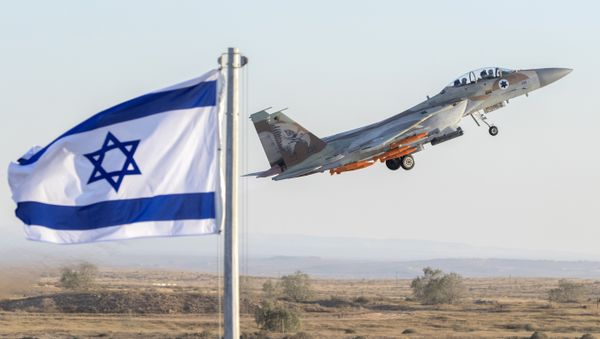 An Israeli Air Force F-15 Eagle fighter plane performs at an air show during the graduation of new cadet pilots at Hatzerim base in the Negev desert, near the southern Israeli city of Beer Sheva, on June 29, 2017 - Sputnik International