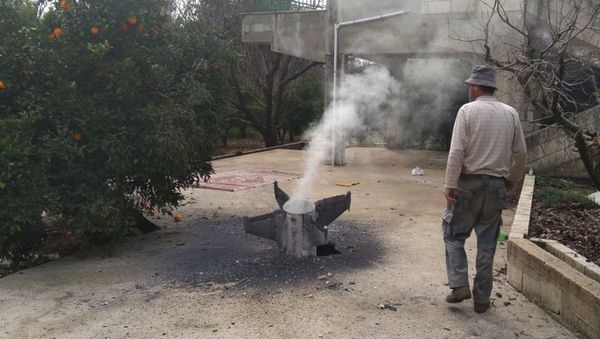 A Lebanese farmer inspects a missile, which according to the Lebanon national news agency is part of a Syrian air defense missile targeting an Israeli warplane - Sputnik International