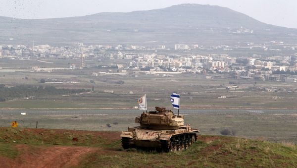 An old military vehicle can be seen positioned on the Israeli side of the border with Syria, near the Druze village of Majdal Shams in the Israeli-occupied Golan Heights, Israel February 11, 2018 - Sputnik International